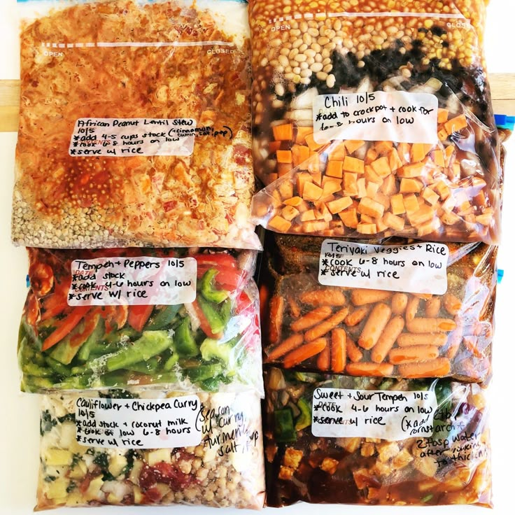 four bags filled with different types of vegetables on top of each other and labeled with labels