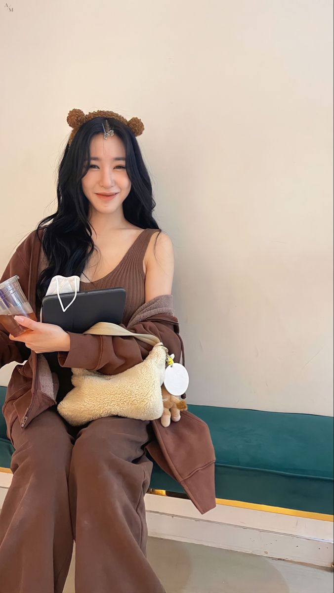 a woman sitting on a bench holding a stuffed animal