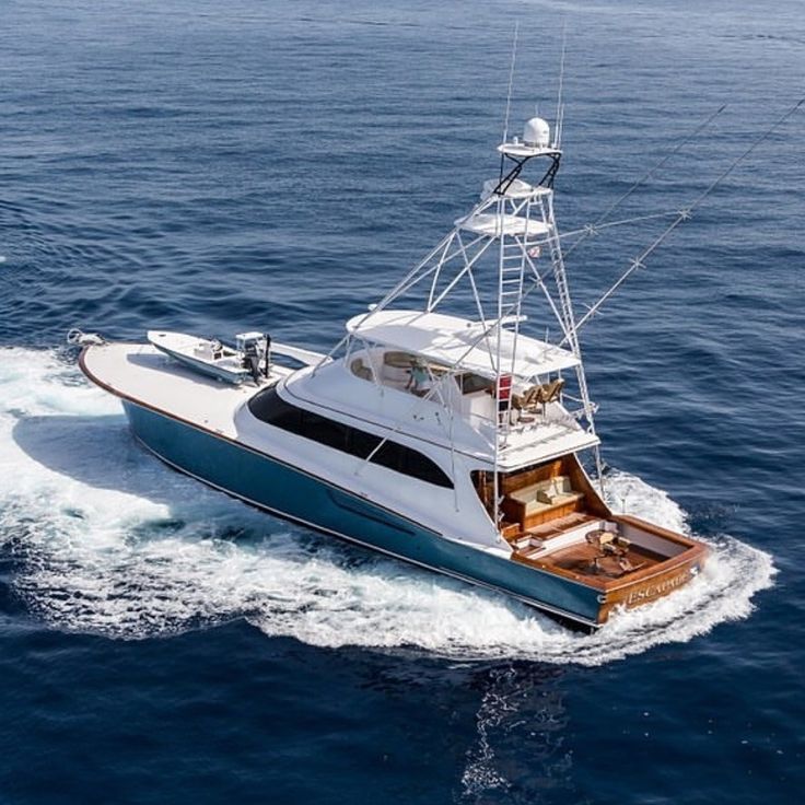 a white and blue boat in the ocean