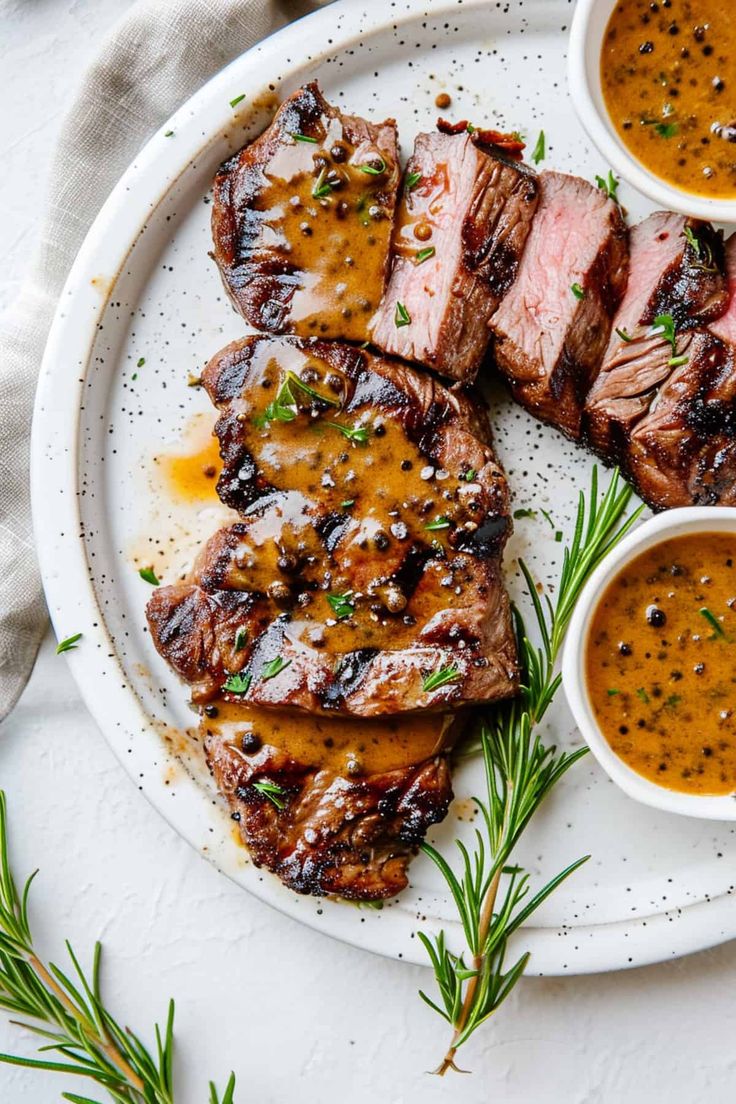 grilled steaks with mustard sauce on a white plate