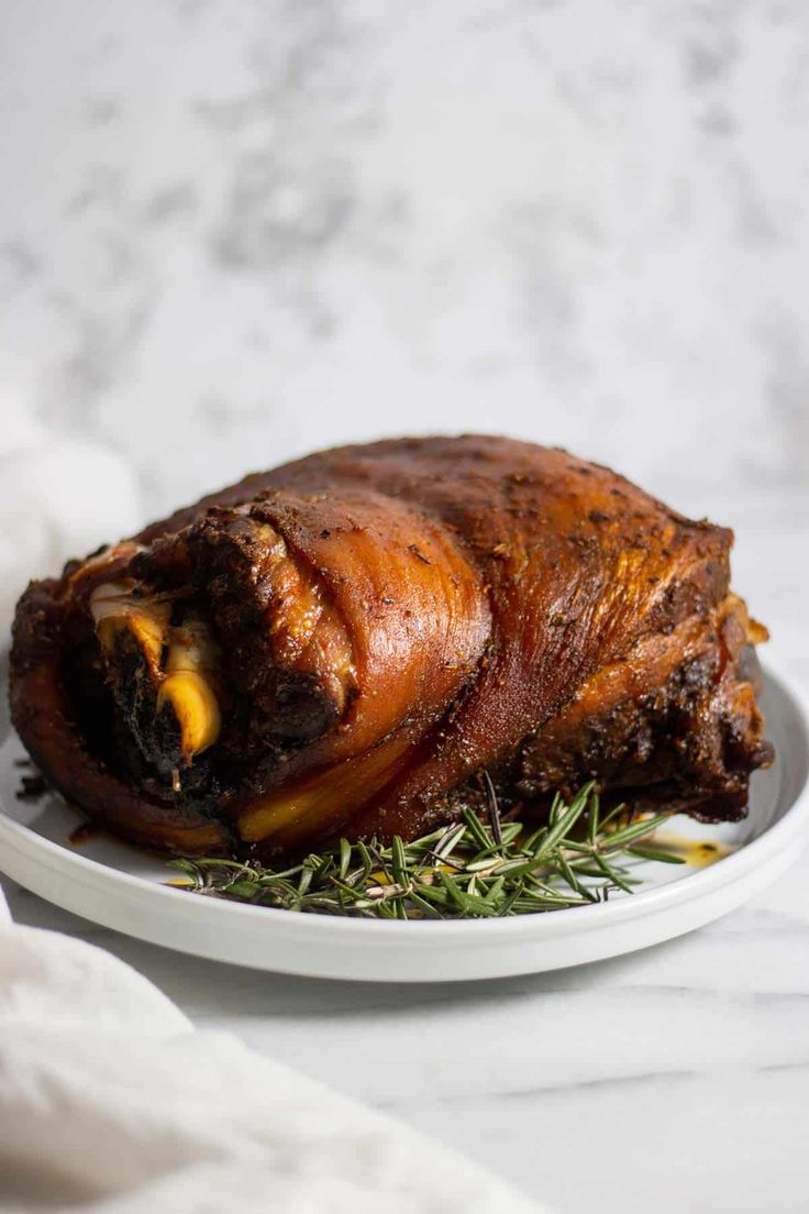 a large piece of meat sitting on top of a white plate