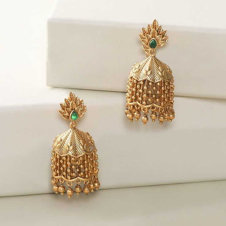 About the Jewelry This leafy designer, Lata jhumkis gives you all the feel of a wedding ceremony. The shower of golden dots makes it much more ravishing and delightful. Crafted with golden brass and high-quality CZ stone, they are light on the ears for maximum comfort. Styling Tip Makes a perfect match with simple ethnic wear. Details & Specifications: Materials used: Brass Metal with Antique Plating Weight - Earrings 23 gm Length - Earrings 4.5 cm Make it custom Want to make it a custom earring Luxury Gold Jhumkas For Anniversary, Luxury Brass Latkan Earrings, Luxury Intricate Design Jhumkas, Luxury Temple Jewelry Jhumkas For Reception, Luxury Gold Jhumkas For Navratri, Cheap Gold Chandbalis For Festive Occasions, Luxury 22k Gold Chandbalis For Festive Occasions, Luxury Bollywood Style 22k Gold Chandbalis, Long Buttalu Earrings Gold