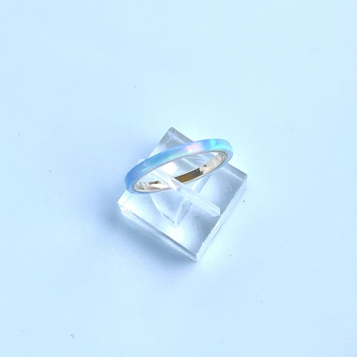 **Current processing time has been reduced to 6-8 weeks. Each ring is made to order in the order received. Thank you so much for your support and patience! 🎁 FREE Wood Ring Box with every ring purchase! 2mm wide Kyocera Solid Opal Ring shimmering with Blue and Turquoise hues. The opal is translucent and when the light hits it, the gold ring comes through in hints of pink. Wrapped around a 14K Gold filled band. Perfect for stacking with a wedding ring or stand alone for a minimalist look. Great Turquoise Opal Rings Perfect For Gifts, Blue Opal Promise Ring, Turquoise Opal Rings For Gift, Turquoise Opal Rings As Gift, Turquoise Opal Rings For Gifts, Adjustable Blue Opal Ring, Blue Opal Round Ring, Blue Round Opal Ring, Adjustable Blue Moonstone Promise Ring