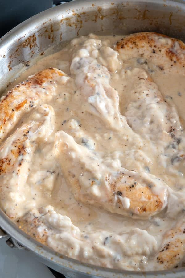 a skillet filled with chicken covered in gravy