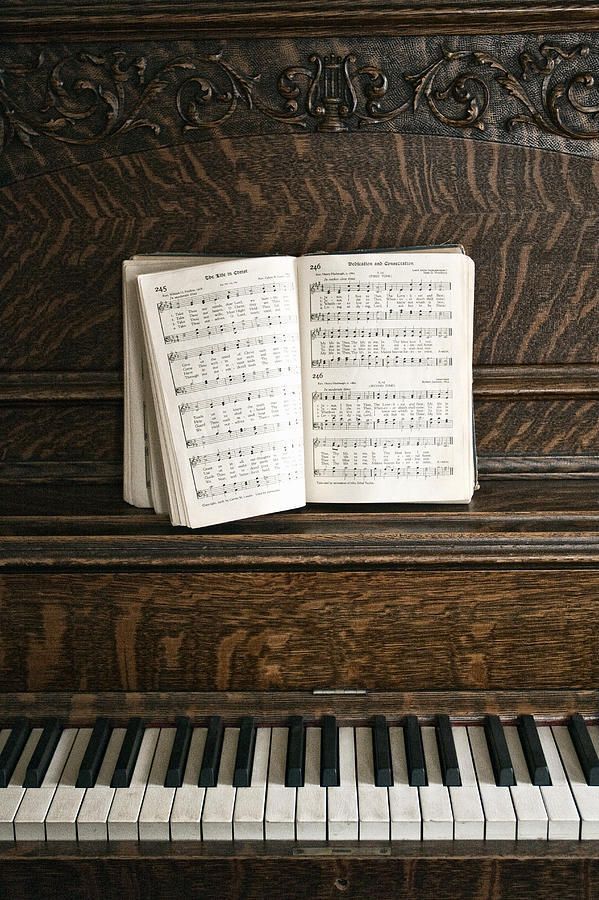 an open book sitting on top of a piano