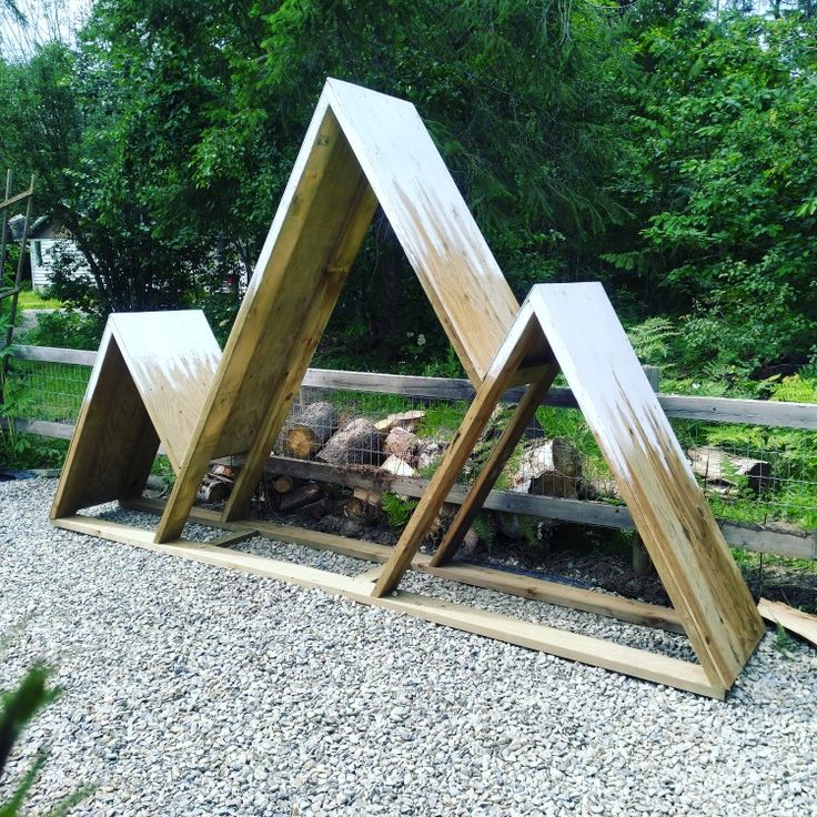 three wooden structures sitting on top of gravel