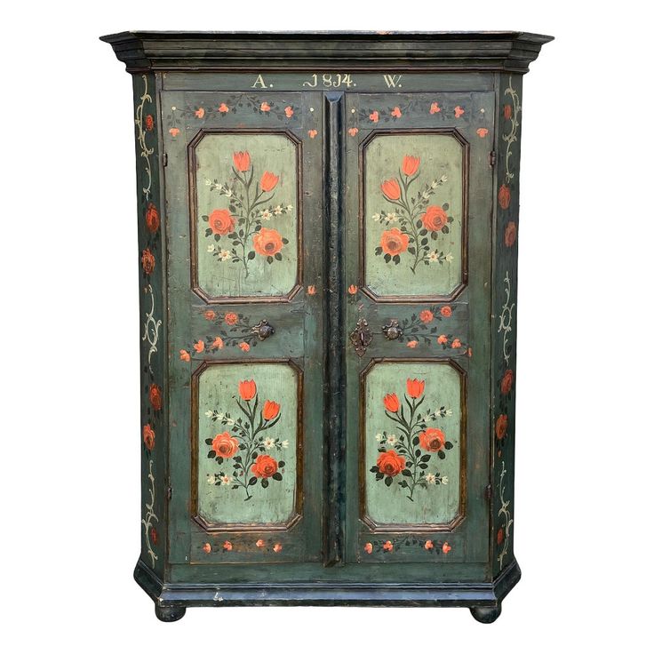 an old painted cabinet with flowers on it