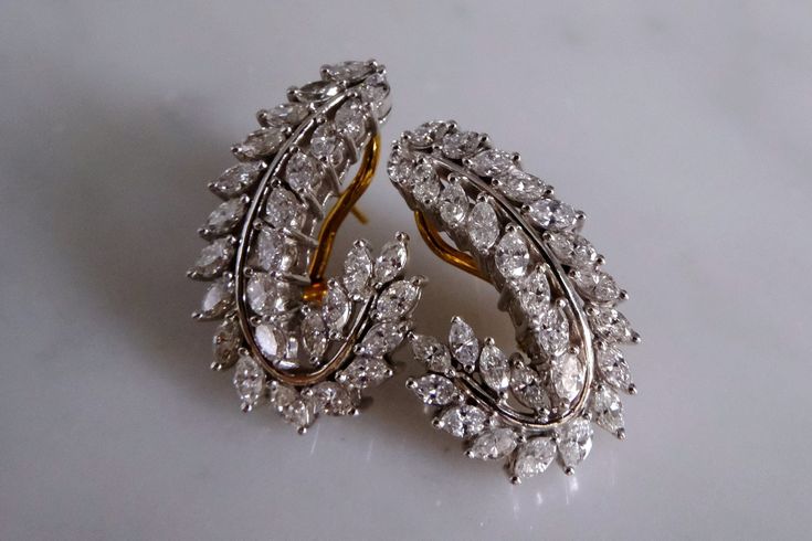 Fine statement earrings set with marquise diamonds weighing 3ctw in 18k. This is a vintage pair that was custom made to a high jewelry style, as opposed to high street trendy. The marquise diamonds are used to their best, they do not look small as they are not lost to the eye. Using the marquise in a feather or leaf not only gives it shape but asymmetry.  On the ears one would wear each side deliberately.  The single curve is a classic form, though at almost 3cm tall these earrings are considere Luxury Marquise Diamond Earrings For Formal Occasions, Luxury Marquise Diamond Earrings For Evening, Formal Diamond Earrings With Diamond Eyes, Classic Diamond Earrings With Diamond Eyes For Formal Occasions, Marquise Single Cut Diamond Earrings For Formal Events, Marquise Single Cut Diamond Earrings For Formal Occasions, Marquise Diamond Earrings For Evening, Luxury Marquise Cut Diamond Earrings For Formal Events, Luxury Marquise Cut Diamond Earrings