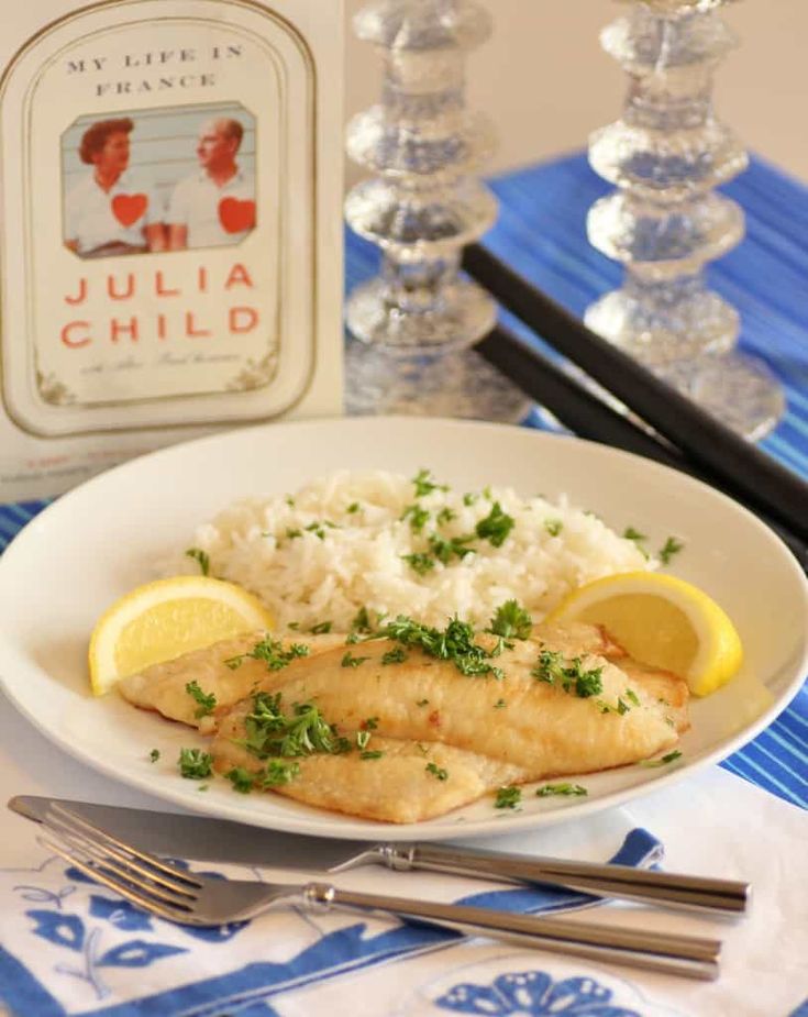 a white plate topped with fish and rice