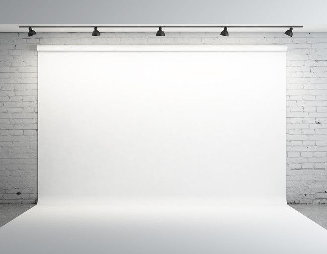 an empty white room with brick walls and lights