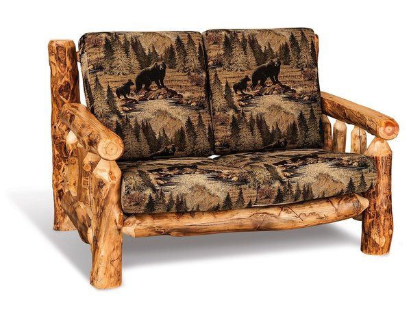 a couch made out of logs with a bear on it