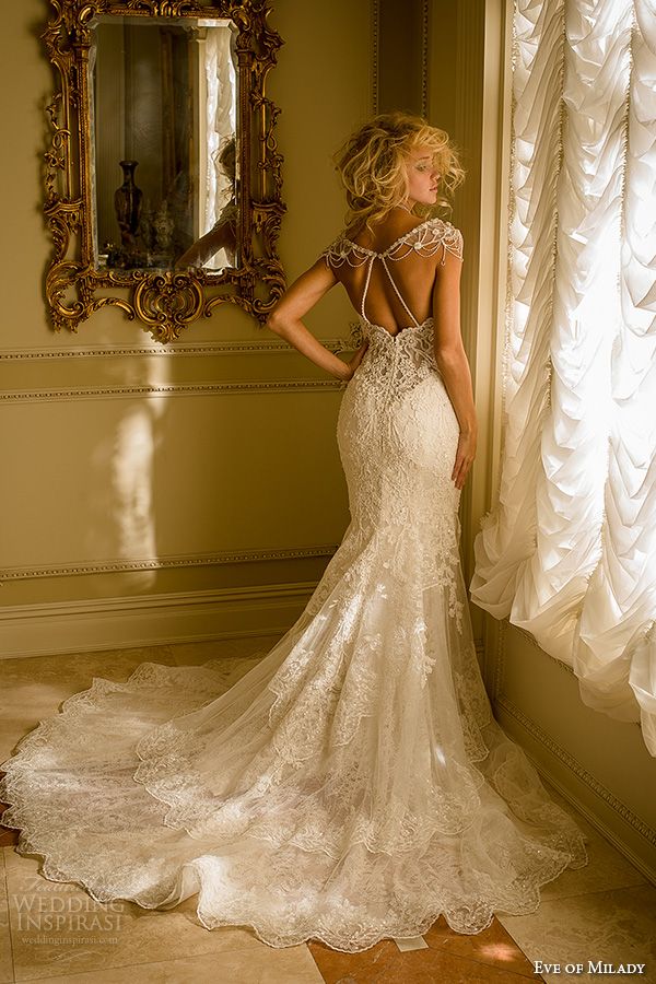 a woman in a wedding dress is looking at her own photos on the web page