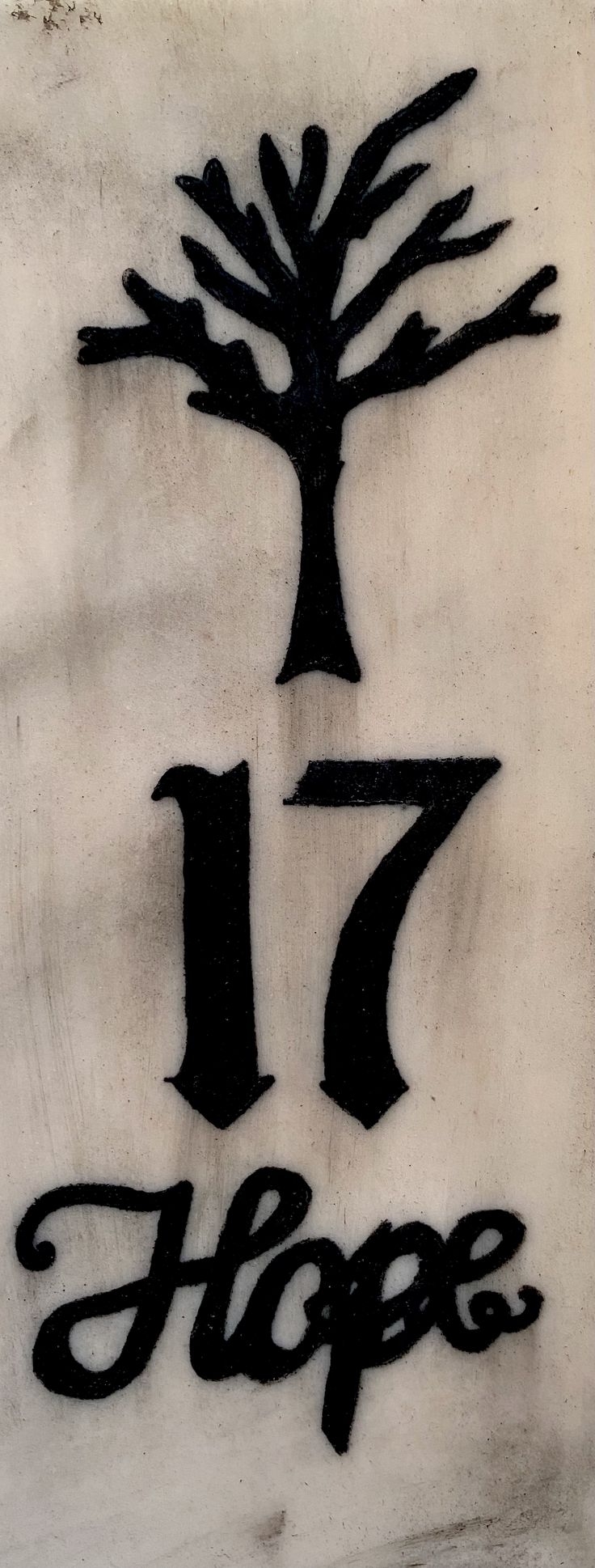 a black and white sign that says 17 hope with a tree in the middle on it