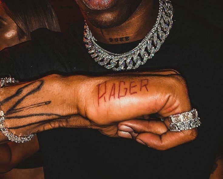 a close up of a person's arm with the word rager written on it