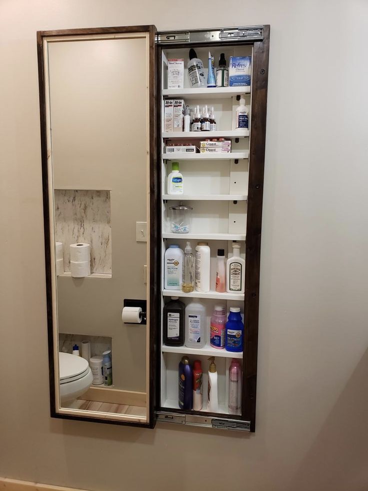 the medicine cabinet is open to reveal its contents