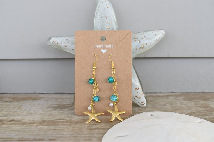 These beachy dangle earrings are handmade and hand assembled with beachy vibes in mind!  The material is delicate and should not be worn in water or with oils and lotions! Summer Beach Earrings With Wire Wrapped Detail, Summer Beach Wire Wrapped Earrings, Bohemian Summer Jewelry In Ocean Color, Summer Bohemian Blue Jewelry, Summer Bohemian Ocean Color Jewelry, Handmade Starfish Earrings For Beach, Summer Starfish Charm Drop Earrings, Summer Bohemian Style Blue Jewelry, Beach Wire Wrapped Drop Earrings