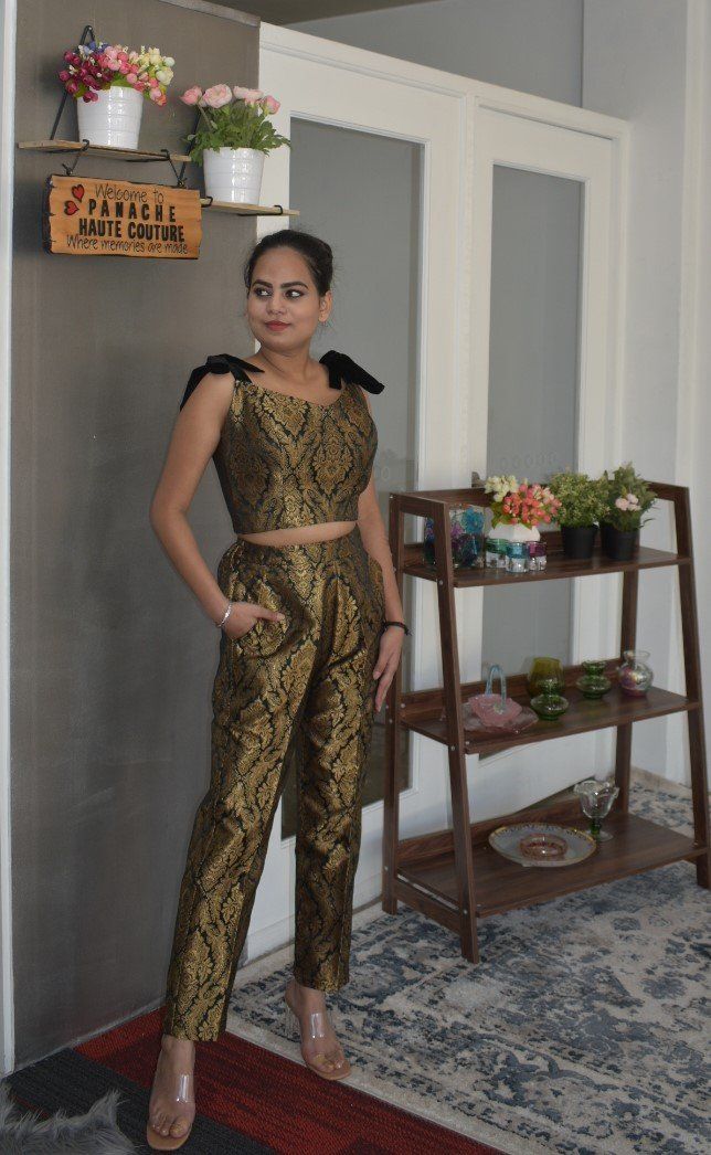 Attractive Banarasi Brocade Trouser with a Blouse Be the lively, beautiful you with an undying spirit as you wear this stylish Banarasi Brocade silk trouser set. This attire has a chic combination of trouser and a blouse with a printed panel detail, which is drool-worthy. Each piece of this outfit is crafted using the excellent quality of material that gives you a stylish and comfortable look. This attractive outfit will shower you compliments for your rich sense of style. This outfit is perfect Elegant Sleeveless Palazzo Set For Festivals, Festive Sleeveless Pant Set For Party, Elegant Sleeveless Palazzo Set For Eid, Fitted Sleeveless Pant Set For Festive Occasions, Festive Fitted Sleeveless Pant Set, Elegant Sleeveless Navratri Sets, Fitted Sets With Straight Pants For Diwali, Elegant Sleeveless Sets For Eid, Fitted Sleeveless Pant Set For Wedding