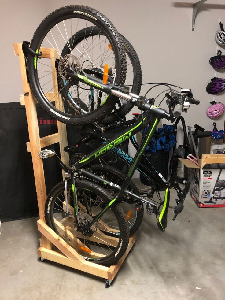 there is a bike on the rack in the garage