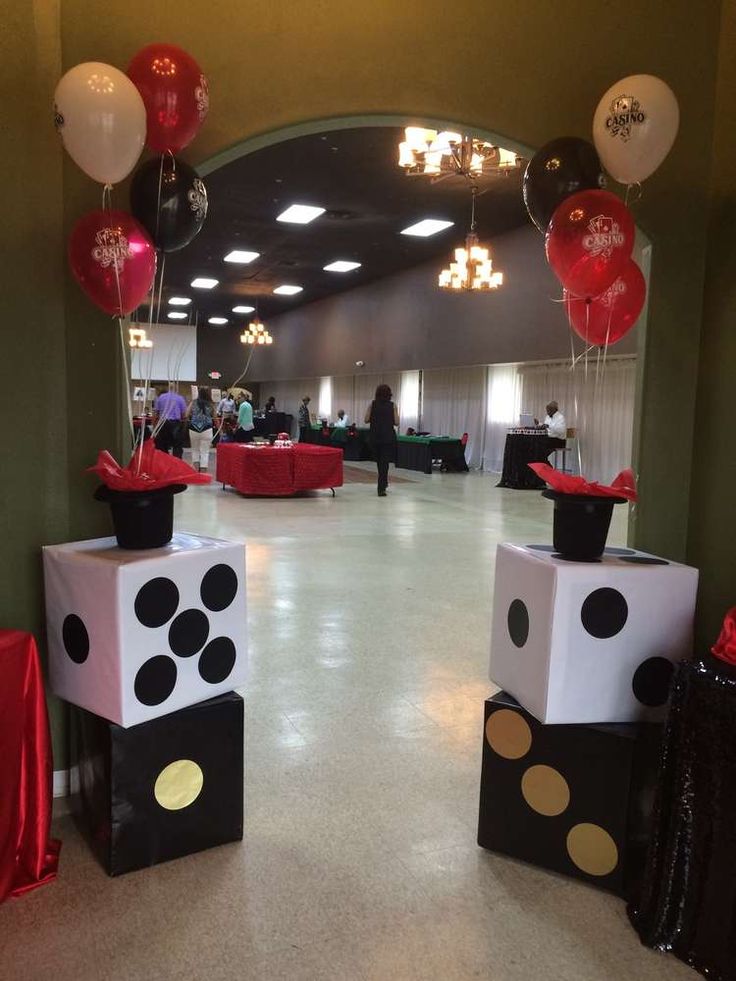 some black and white boxes with balloons on them in the middle of a floored area