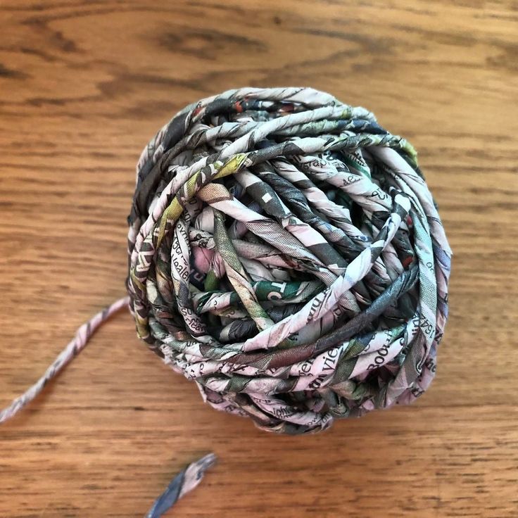 a ball of yarn sitting on top of a wooden table