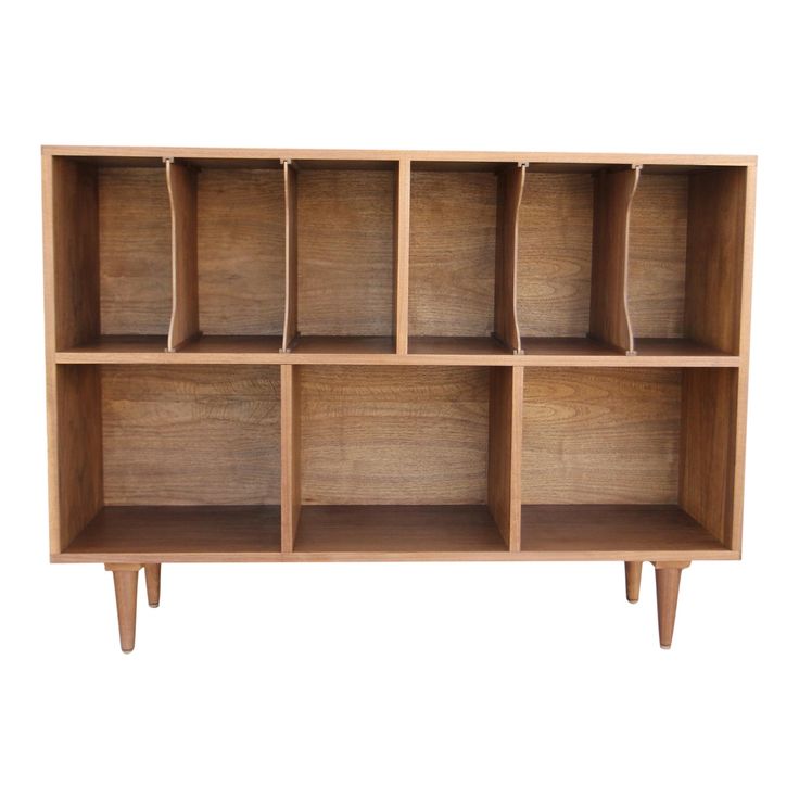 a wooden shelf with six compartments on one side and four legs, in the shape of an open bookcase