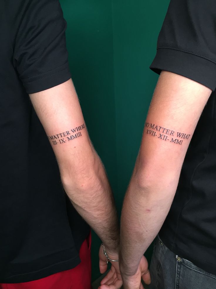 two people holding hands with tattoos on their arms that say, whatever here is the same