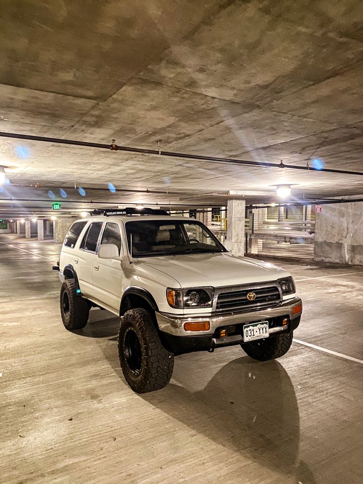 a white truck parked in a parking garage