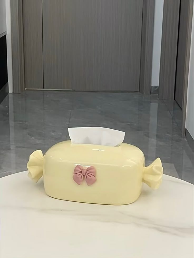 a yellow toilet sitting on top of a white table