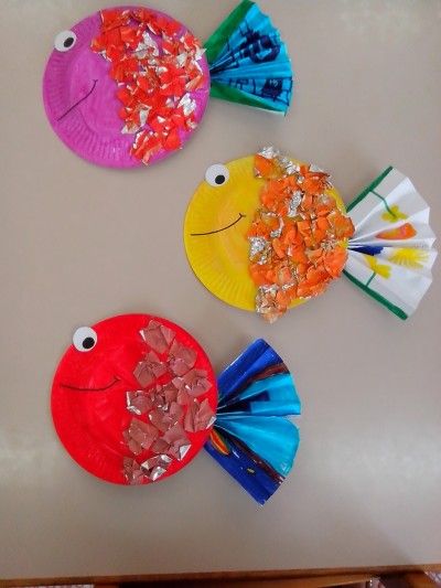 three paper plates with fish on them