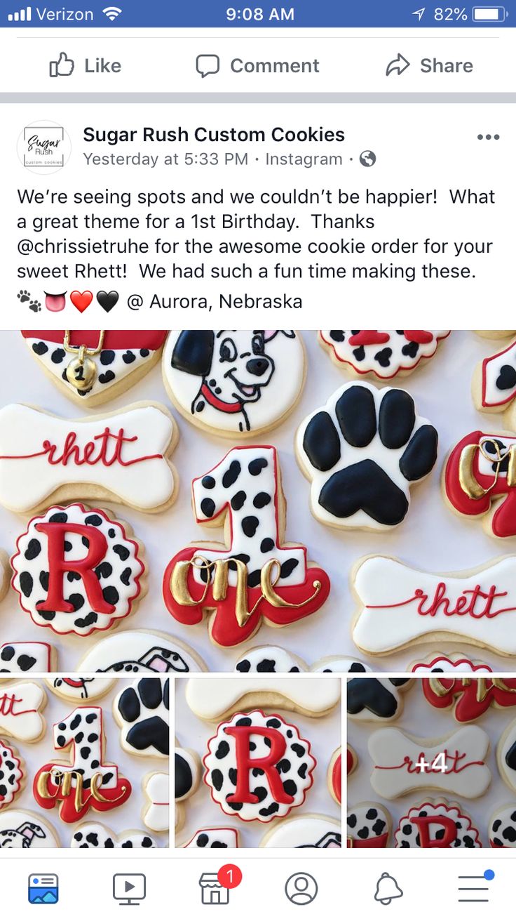 the cookies are decorated with black and white polka dots, red letters, and paw prints