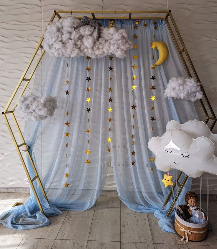 a child's room with clouds, stars and moon decorations