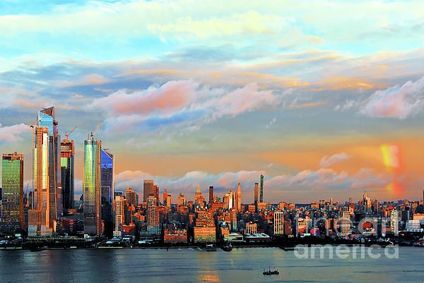 the city skyline is lit up at sunset as clouds loom in the sky over the water