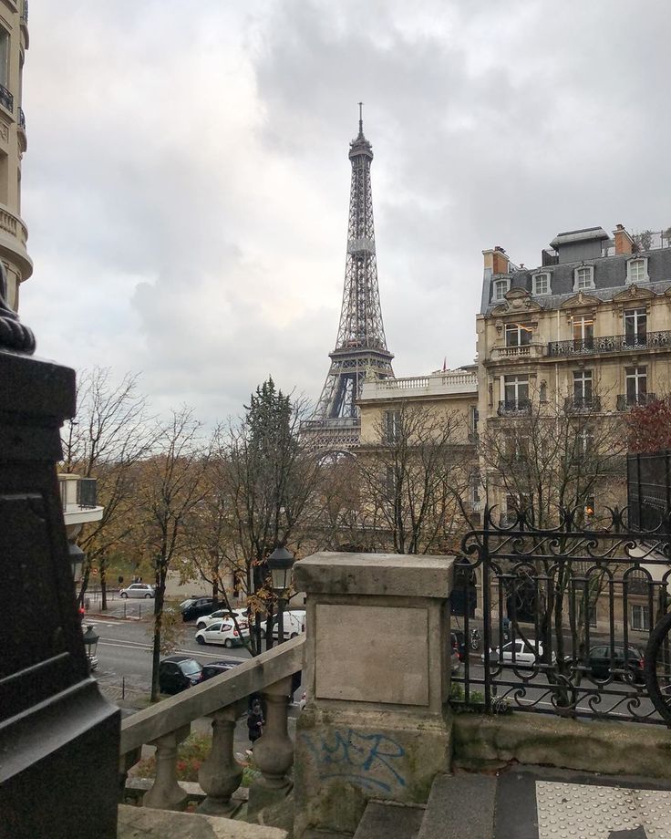 the eiffel tower is in the distance behind some buildings