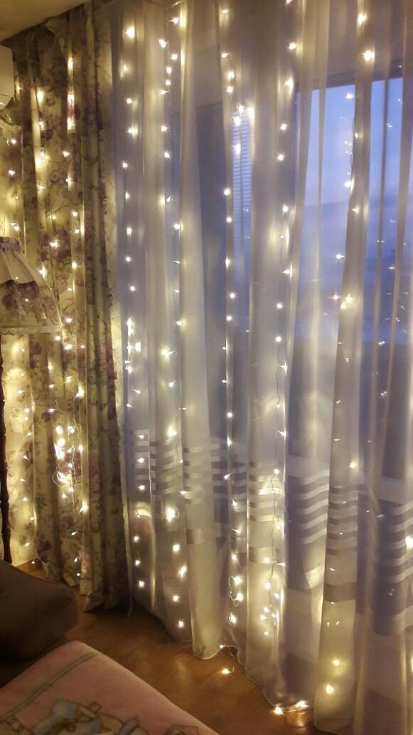 the curtains are covered with white lights