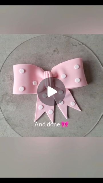 a pink bow with white polka dots on it and the words and donee written below