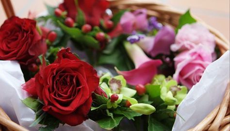 a basket filled with lots of flowers on top of a table