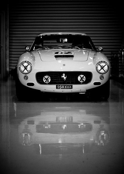 a classic sports car parked in a garage