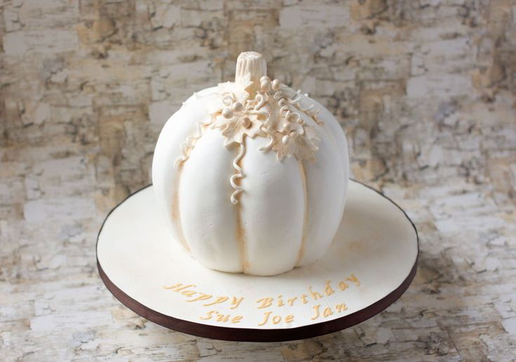 there is a white pumpkin on top of the cake