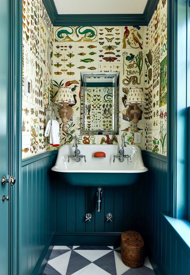 a bathroom with a sink, mirror and wallpapered walls in the corner area