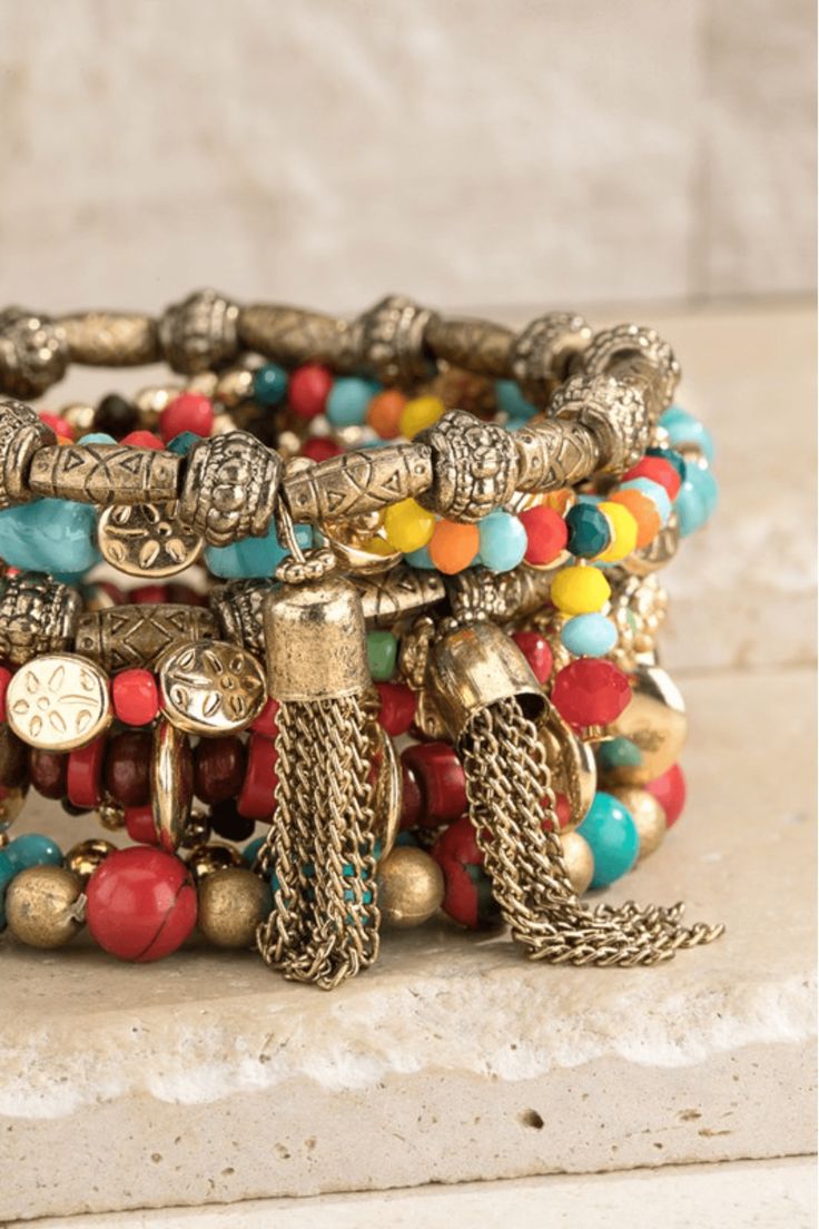 Elegant bohemian-inspired stretch bracelet featuring multi-layered, colorful mixed wood, stone, and metal beads. The combination of textures and hues gives this bracelet a unique and eye-catching look. Made with acrylic, wood beads, and zinc, this bracelet is also nickel/lead compliant for added safety. Measuring approximately 9.25 inches in length and 2.5 inches in diameter, this bracelet will add a touch of boho-chic to any outfit. Imported for the highest quality. Wood Beads Jewelry, Classy Yet Trendy, Memorial Bracelet, Inspirational Bracelets, Bohemian Bracelets, Wood Stone, Layered Bracelets, Jasper Beads, Lovely Jewellery