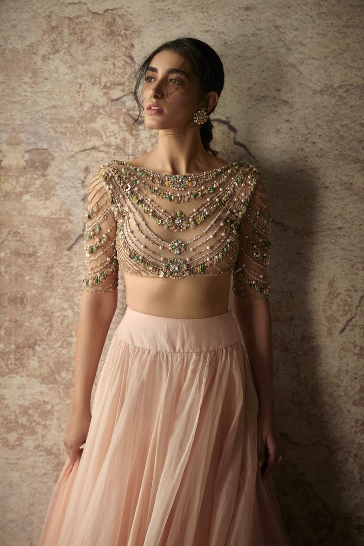 This set features a jeweled champagne blouse paired with a peach organza skirt and an embroidered dupatta. Color: Peach & Champagne Fabric: Net; Organza Care: Dry Clean Only Champagne Blouse, Champagne Skirt, Peach Lehenga, Ridhi Mehra, Organza Lehenga, Indian Outfits Lehenga, Lehenga Blouse Designs, Gaun Fashion, Organza Skirt