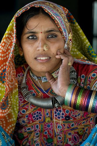 a woman in colorful clothing talking on her cell phone