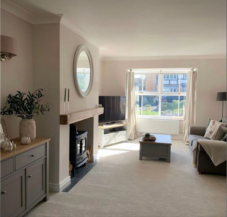 a living room filled with furniture and a fire place