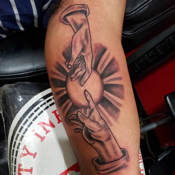 a black and white photo of a man's arm with a tattoo on it