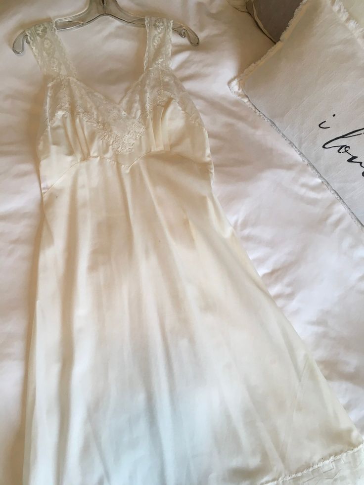 "Vintage NOS White Parisian Maid Nightgown Size 32, Vintage Lingerie Ethereal white Parisian Maid nightgown with beautiful lace on the bodice with cutwork. The same lace is around the armholes and around the hemline. Wide lace straps. Fitted top with a full gathered bottom. Made from Dacron Nylon and Cotton fabric. It's on the original manufacturer hanger. Excellent vintage condition with some dirty spots. Will need washed. Priced accordingly. Please look at the photos carefully because they are White Vintage Dress, French Lingerie, Cotton Slip, Lingerie Photos, Lingerie Sets, Lace Straps, Slip Skirt, Chapel Hill, Fitted Top