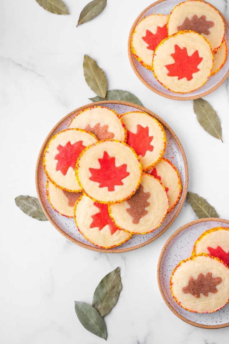 maple leaf cookies on plates with leaves around them