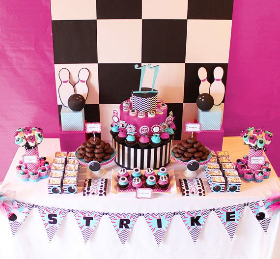 a table topped with lots of cakes and cupcakes