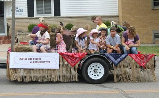 a group of people riding on the back of a truck