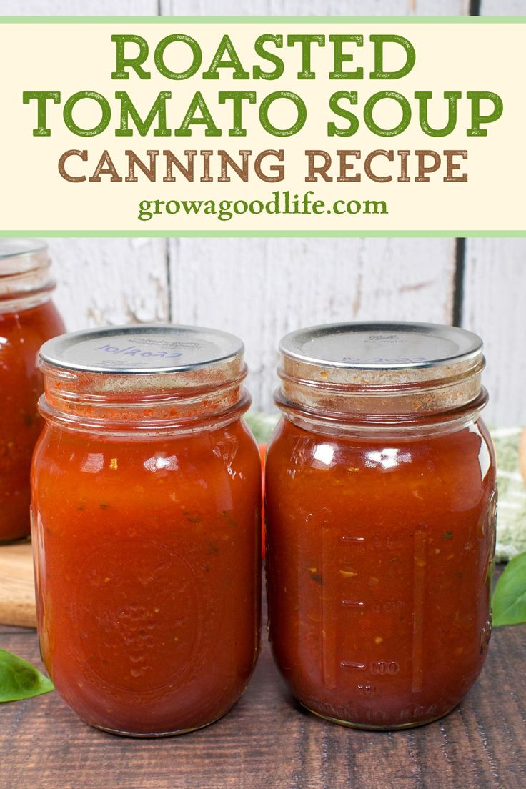 three jars filled with roasted tomato soup sitting on top of a wooden table