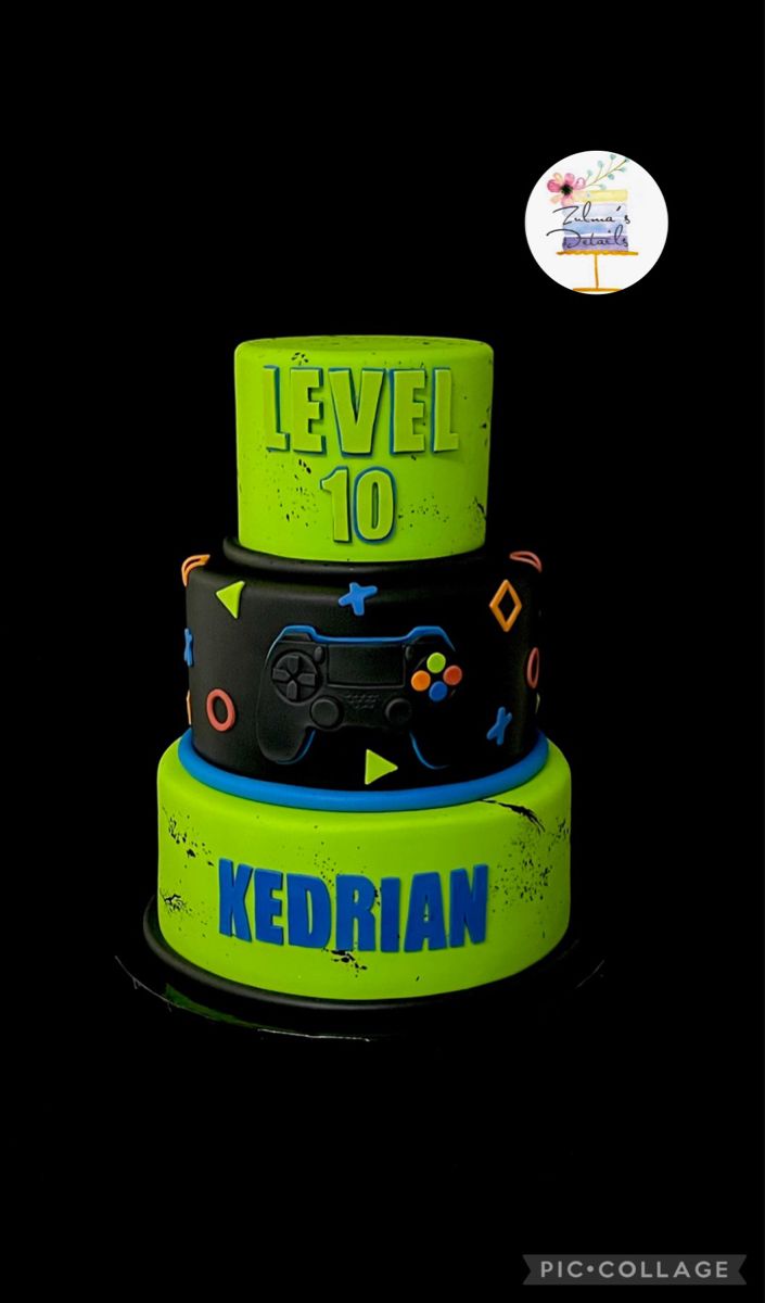 a three tiered cake with video game controllers on it's sides and the words level 10